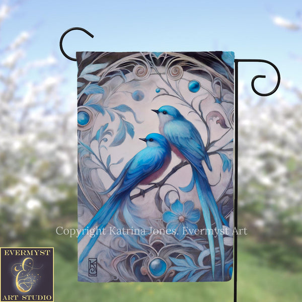 A flag featuring a painting of two blue birds perched on a branch, surrounded by intricate floral designs and blue gemstones.