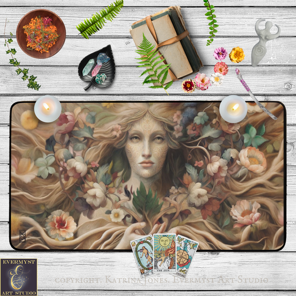 a large painting of a woman's face surrounded by flowers and plants, with candles and tarot cards placed around it on a wooden surface.