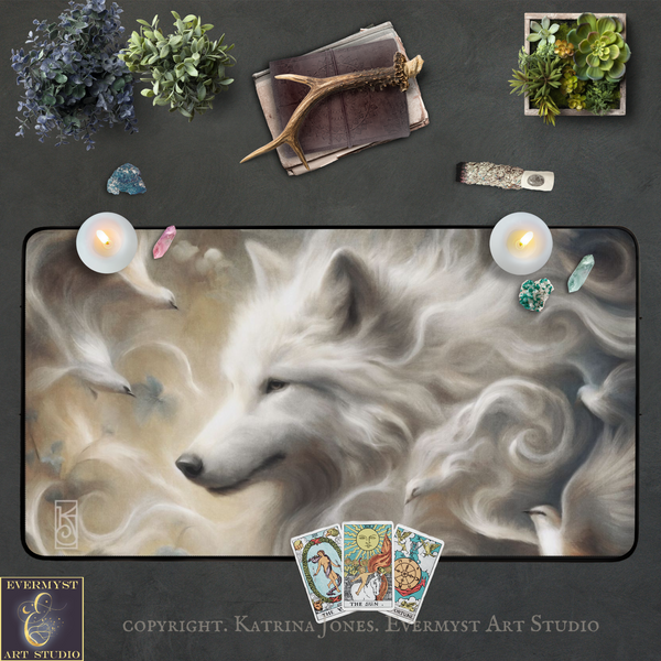 a large painting of a wolf's face surrounded by swirling clouds, with a deck of playing cards and various other objects such as a candle, succulent plants, and a deck of tarot cards arranged around it.