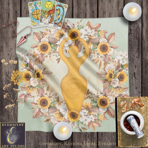 The image is a collage featuring a golden female figure surrounded by a wreath of flowers, candles, and tarot cards.