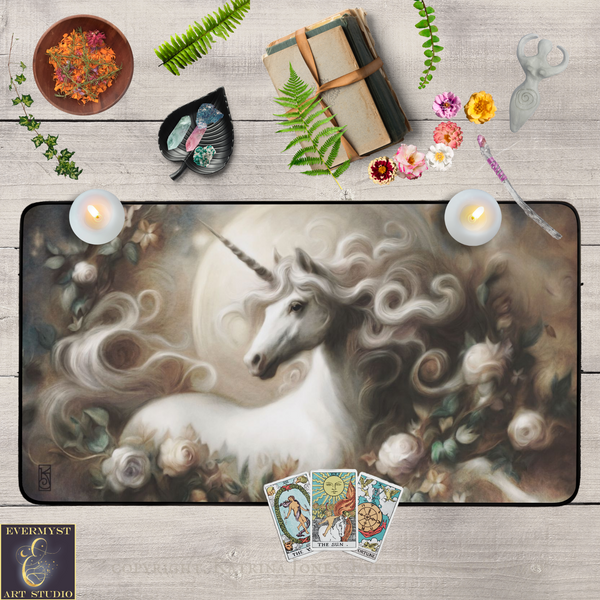 a large painting of a unicorn surrounded by flowers and plants, along with various other objects such as a book, candles, and tarot cards.