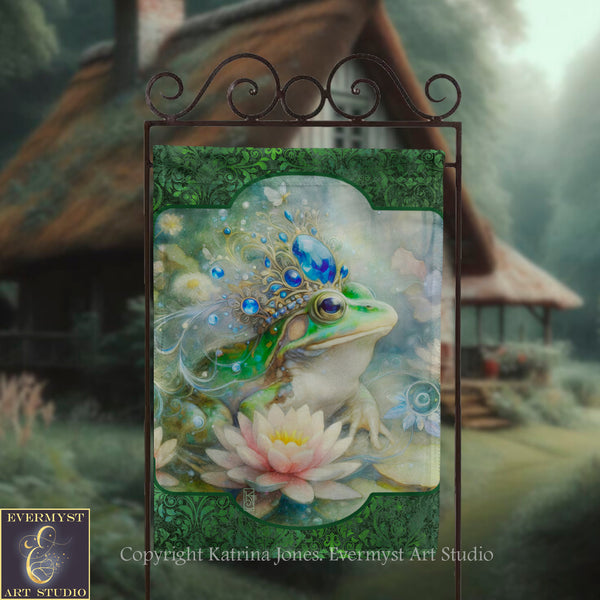 a banner with a painting of a frog wearing a crown and surrounded by flowers, set against a blurred natural background.