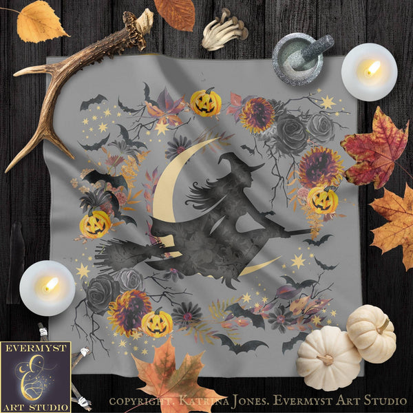 a Halloween-themed design with a witch on a broomstick, surrounded by pumpkins, bats, flowers, and autumn leaves. The design is displayed on a gray background, and there are candles and other Halloween-related items scattered around the scene.