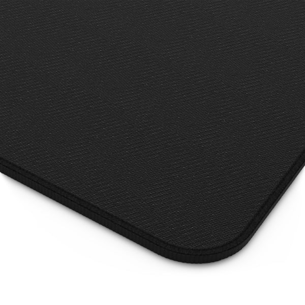 A close-up view of a black, textured surface, such as a piece of fabric or a piece of paper.