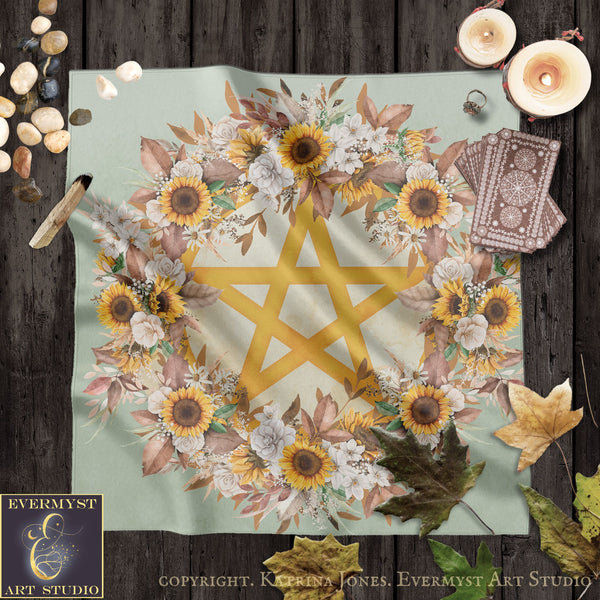 a large floral design with a yellow star at the center, surrounded by various flowers and leaves. The background is a light green color, and there are candles and other objects scattered around the design.