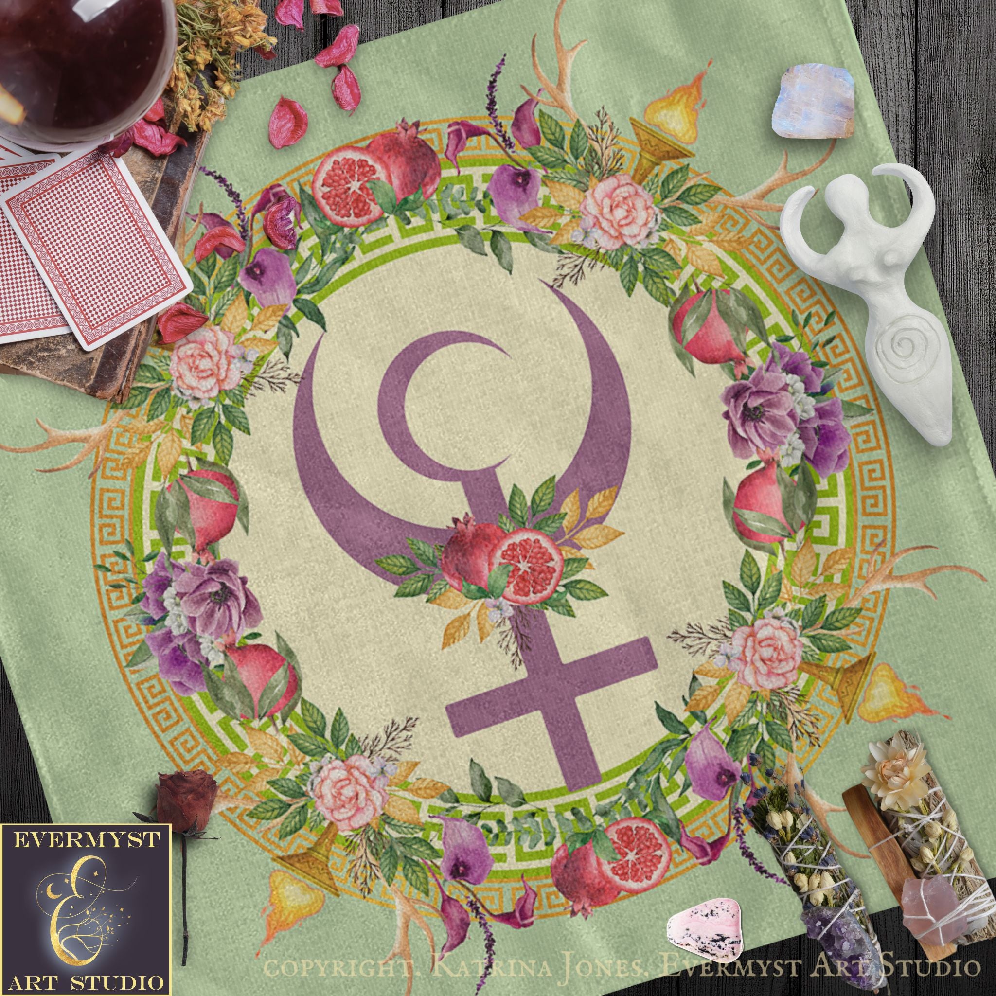 a vibrant and colorful design with a large purple symbol surrounded by a floral wreath, all set against a green background. The design includes various flowers, leaves, and a crescent moon, creating a visually striking and intricate composition.