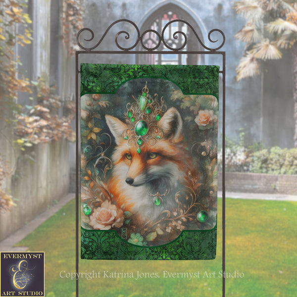 a banner with a fox's face on it, surrounded by flowers and foliage, displayed in front of a stone wall and a garden.