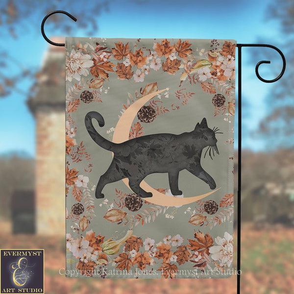 A black cat silhouette is depicted walking on a crescent moon, surrounded by autumn leaves and flowers, with a brick tower in the background.