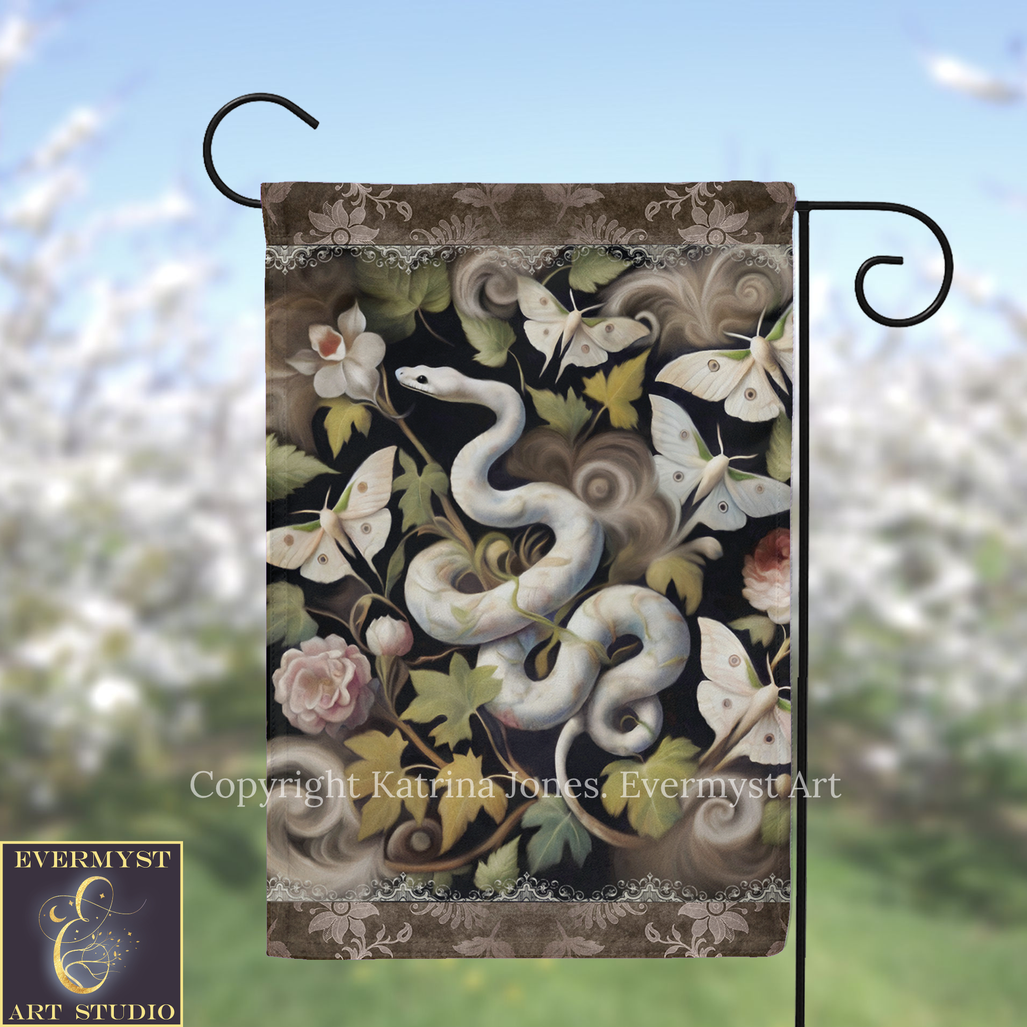 A decorative garden flag featuring a snake surrounded by various flowers, butterflies, and leaves.