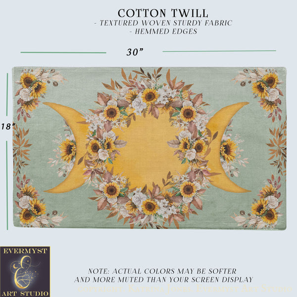 The image is a printed fabric with a floral design featuring sunflowers and crescent moons. The fabric has a textured woven appearance and is described as a cotton twill with hemed edges.