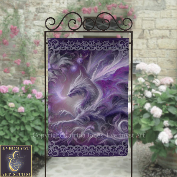 a large, intricate dragon design with purple and white colors, displayed on a decorative metal stand. The dragon appears to be in motion, with its wings spread wide. The background includes a stone wall with pink flowers, creating a visually appealing and artistic setting.