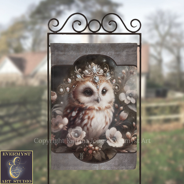 a close-up of an owl wearing a crown of flowers, with a blurred background of trees and a house.