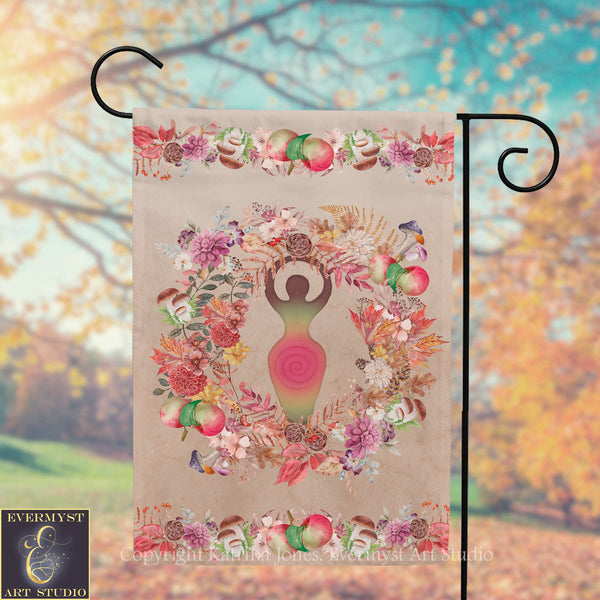 a banner with a colorful floral design and a figure of a woman holding a wreath. The banner is hanging from a metal hook, and the background appears to be a blurred outdoor scene with trees and foliage.