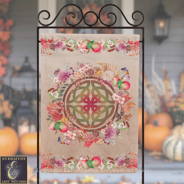 a decorative banner with a floral design and a Celtic knot motif, displayed on a metal stand.