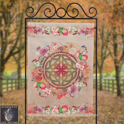 a banner with a circular design and a floral border, hanging in an outdoor setting with trees in the background.