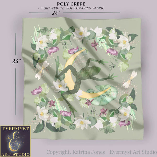 a green scarf with white flowers and a crescent