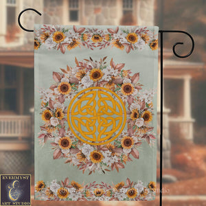 a banner with a floral design and a Celtic knot pattern, hanging on a metal hook.