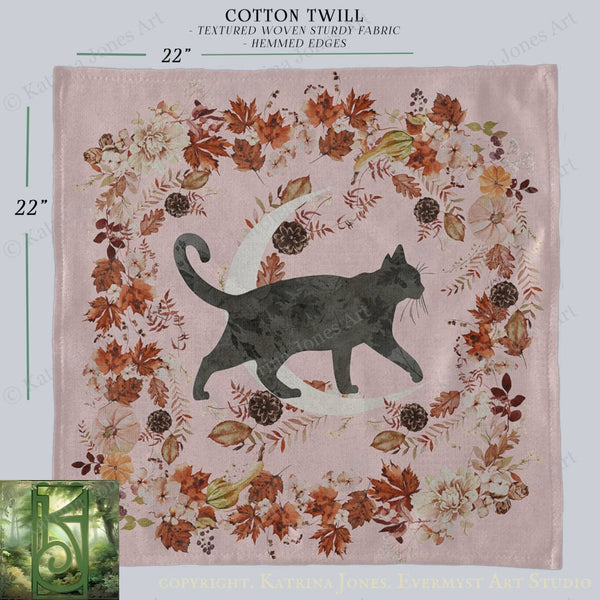 a square-shaped fabric with a black cat silhouette and a crescent moon design, surrounded by a wreath of autumn leaves and flowers.