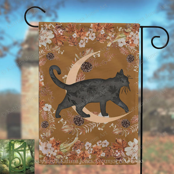 A black cat silhouette is depicted walking on a crescent moon, surrounded by autumn foliage and flowers, with a brick tower in the background.
