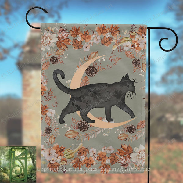 A black cat silhouette is depicted walking on a crescent moon, surrounded by autumn leaves and flowers, with a brick tower in the background.