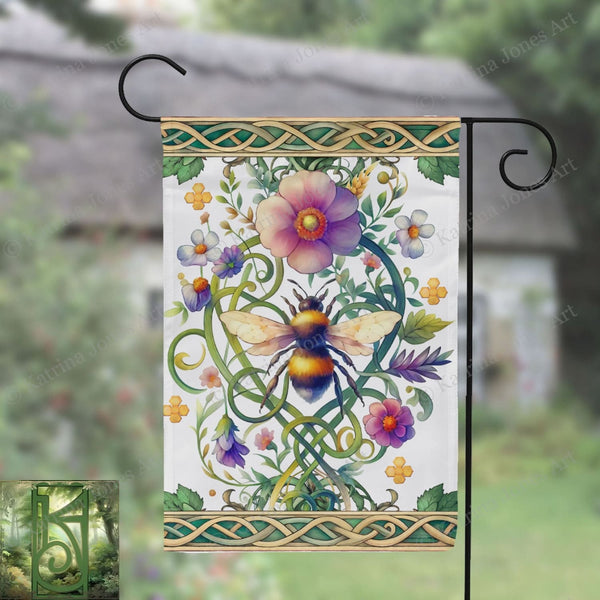 a garden flag hanging from a metal pole