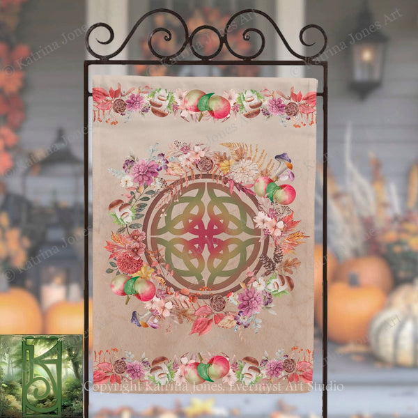 a decorative banner with a floral design and a Celtic knot motif, displayed on a metal stand.