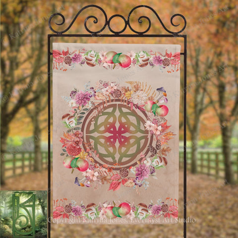 a banner with a circular design and a floral border, hanging in an outdoor setting with trees in the background.
