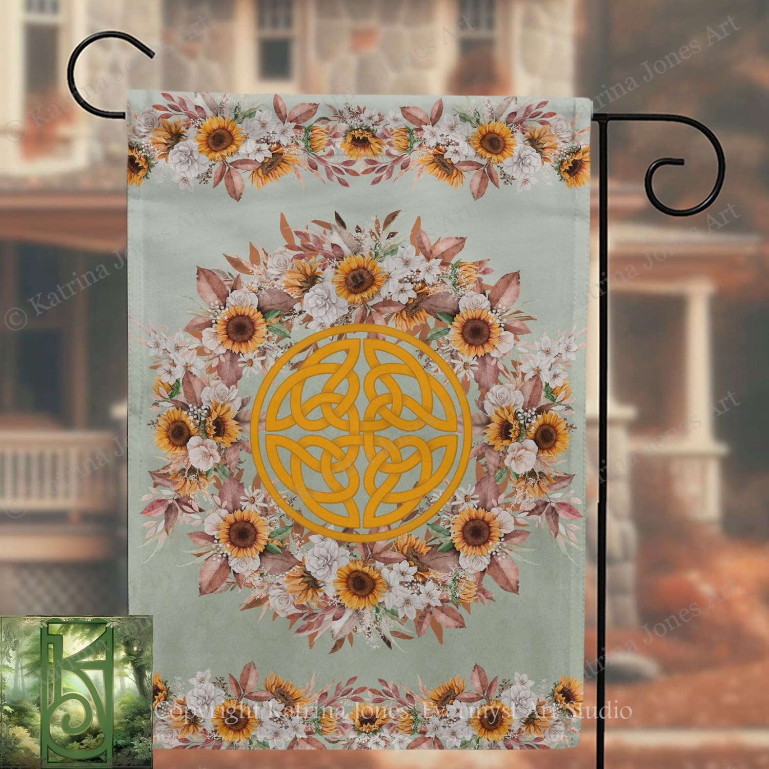 a banner with a floral design and a Celtic knot pattern, hanging on a metal hook.