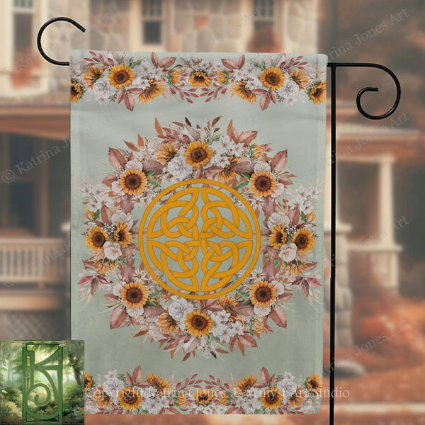 a banner with a floral design and a Celtic knot pattern, hanging on a metal hook.