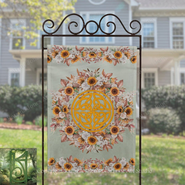 a banner with a floral design and a Celtic knot motif, displayed on a metal stand in front of a house.