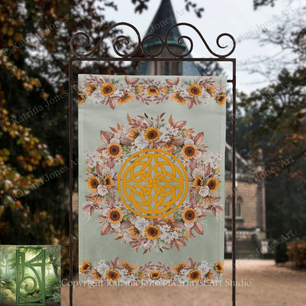 A banner with a floral design and a Celtic knot in the center, displayed outdoors in front of a building.