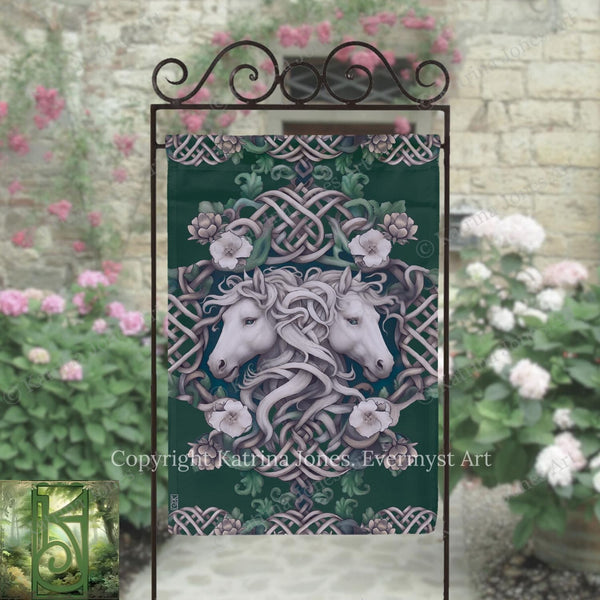 a decorative banner with a floral design and two white horses, placed in front of a stone wall with pink flowers.