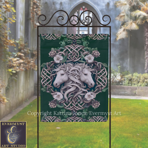 a banner with a white horse and floral design, displayed outdoors in front of a building with a stone archway.