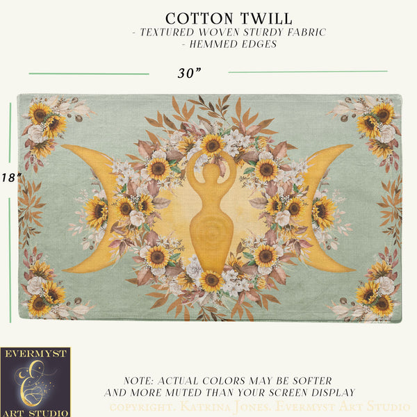 The image is a textile featuring a floral design with a central figure surrounded by sunflowers and other flowers. The design is framed by a border of leaves and flowers, creating a decorative and textured appearance.