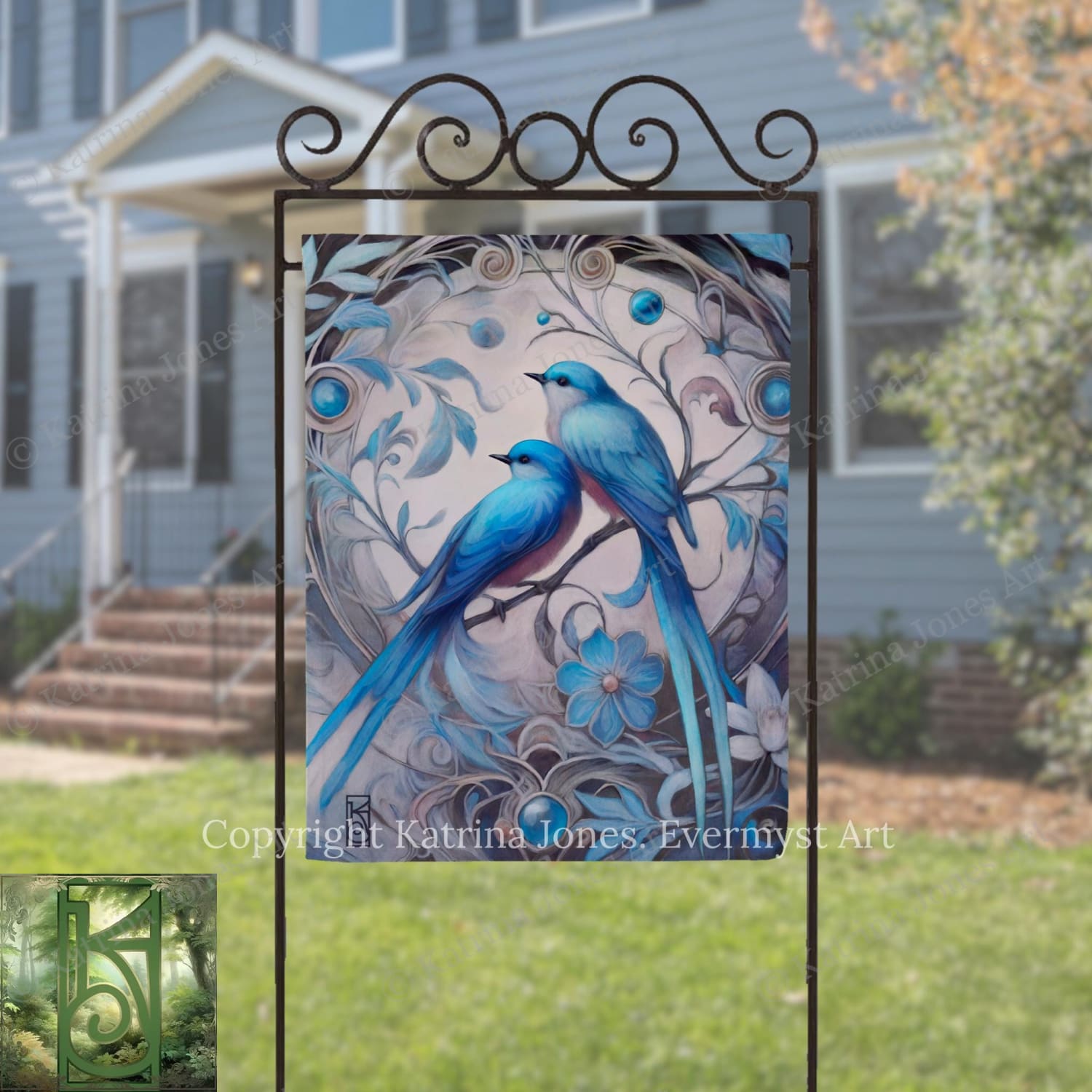 a large, ornate metal sign with a painting of two blue birds perched on a branch, surrounded by intricate floral designs.