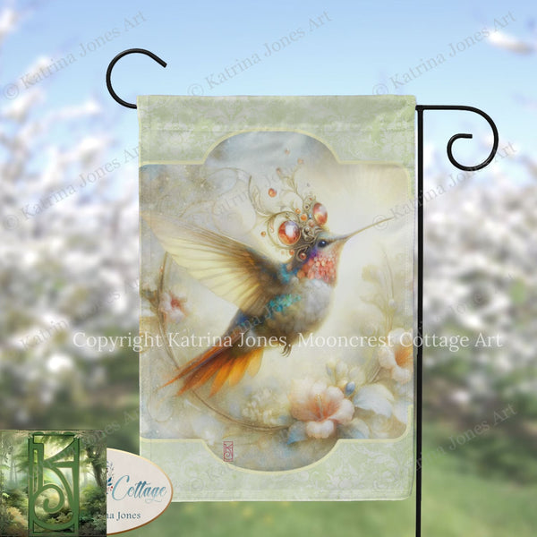 A colorful hummingbird with a decorative headdress is depicted on a flag, set against a blurred background of flowers.