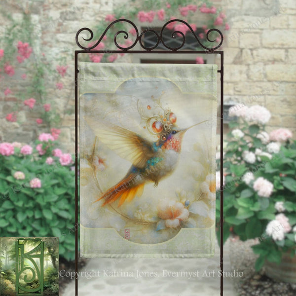 a hanging banner with a colorful hummingbird design, displayed in front of a stone wall with pink flowers.