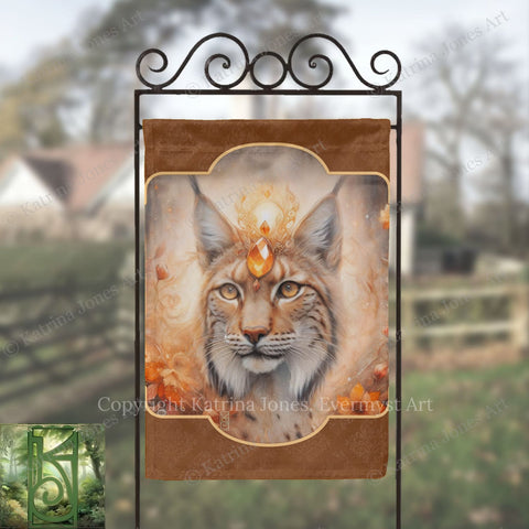 a banner with a close-up of a cat's face, adorned with a crown and a gemstone, set against a blurred background of a garden or outdoor setting.