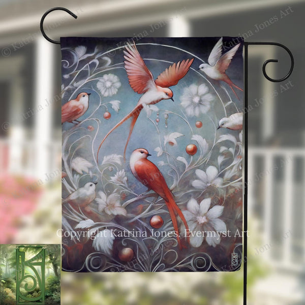 The image is a vibrant painting of several birds in flight, surrounded by flowers and foliage. The painting is displayed on a black metal pole, which is hanging outside a building.