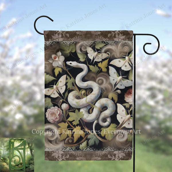 A decorative garden flag featuring a snake surrounded by various flowers, butterflies, and leaves.