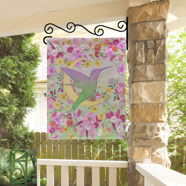 a picture of a hummingbird on a wall hanging on a porch
