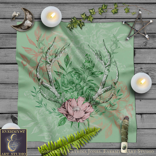 a table topped with a green table cloth covered in deer antlers