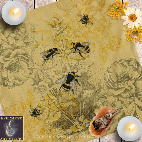 a table topped with bees and flowers next to candles
