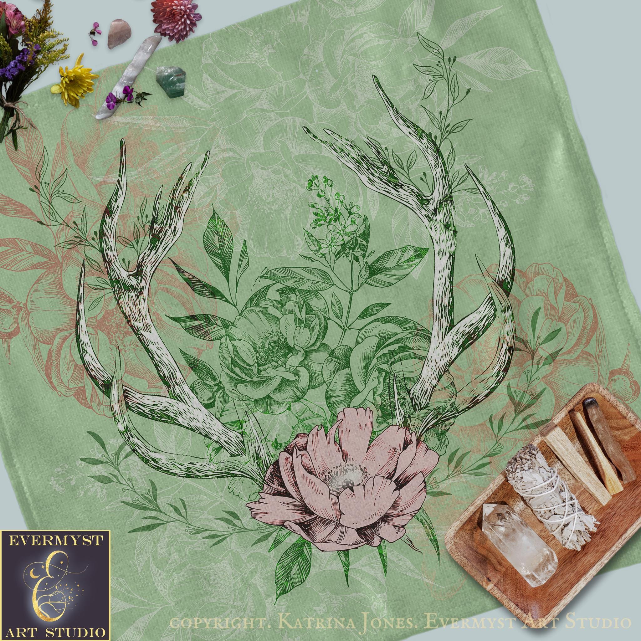 a table with a deer antlers and flowers on it