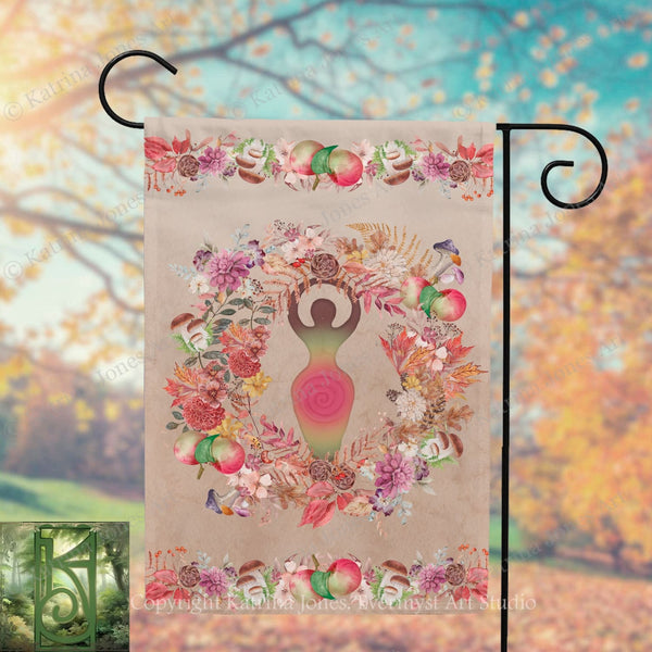 a banner with a colorful floral design and a figure of a woman holding a wreath. The banner is hanging from a metal hook, and the background appears to be a blurred outdoor scene with trees and foliage.