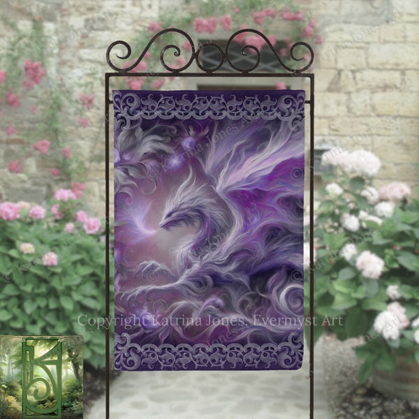 a large, intricate dragon design with purple and white colors, displayed on a decorative metal stand. The dragon appears to be in motion, with its wings spread wide. The background includes a stone wall with pink flowers, creating a visually appealing and artistic setting.