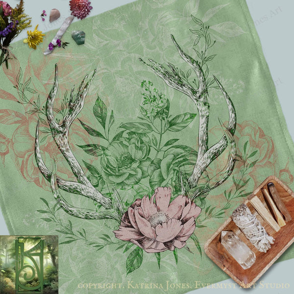 a table with a deer antlers and flowers on it