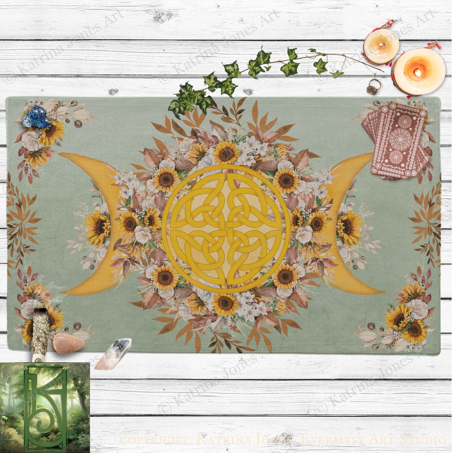a vibrant and intricate design with a central motif of a crescent moon surrounded by sunflowers and other flowers. The design is set against a light green background, and there are candles and crystals placed around the design, adding to the overall aesthetic.