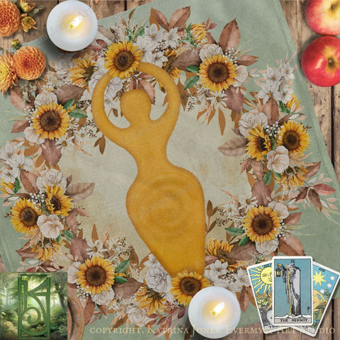 a wreath of flowers surrounding a golden figure, with candles and tarot cards placed around the scene.
