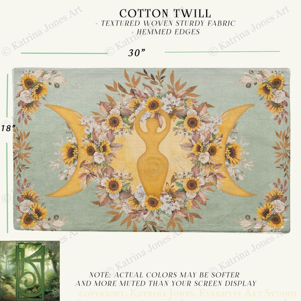 The image is a textile featuring a floral design with a central figure surrounded by sunflowers and other flowers. The design is framed by a border of leaves and flowers, creating a decorative and textured appearance.